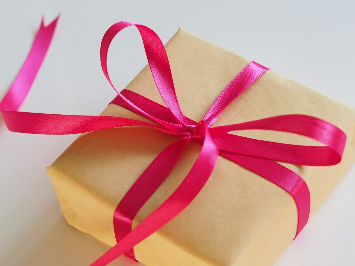 A wrapped gift being passed from one person to another